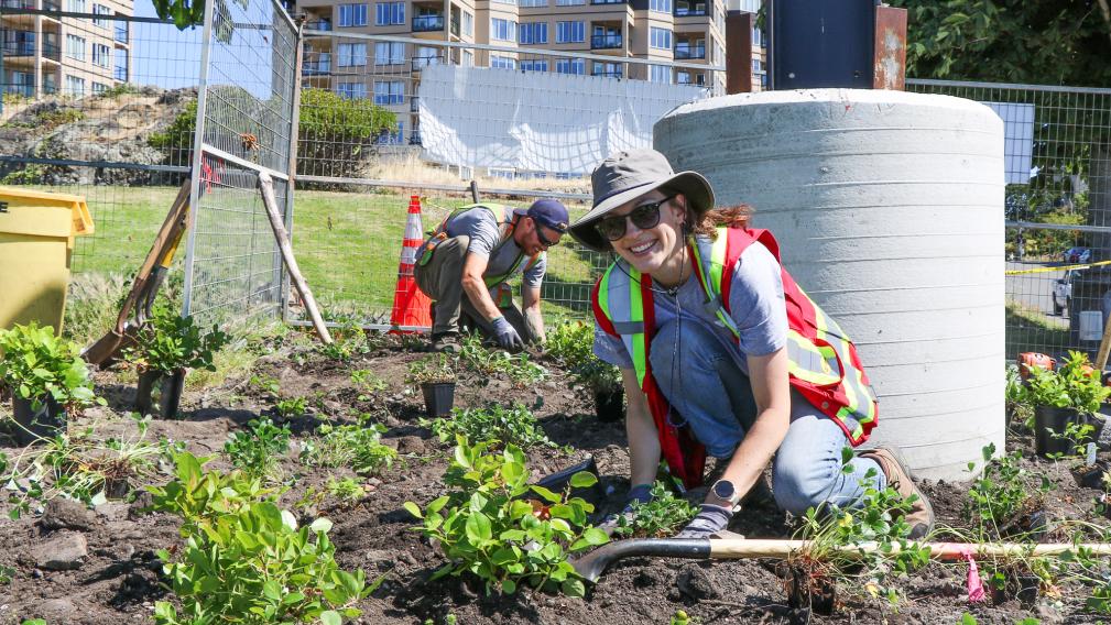 An image of two City workers maintaining a garden bed