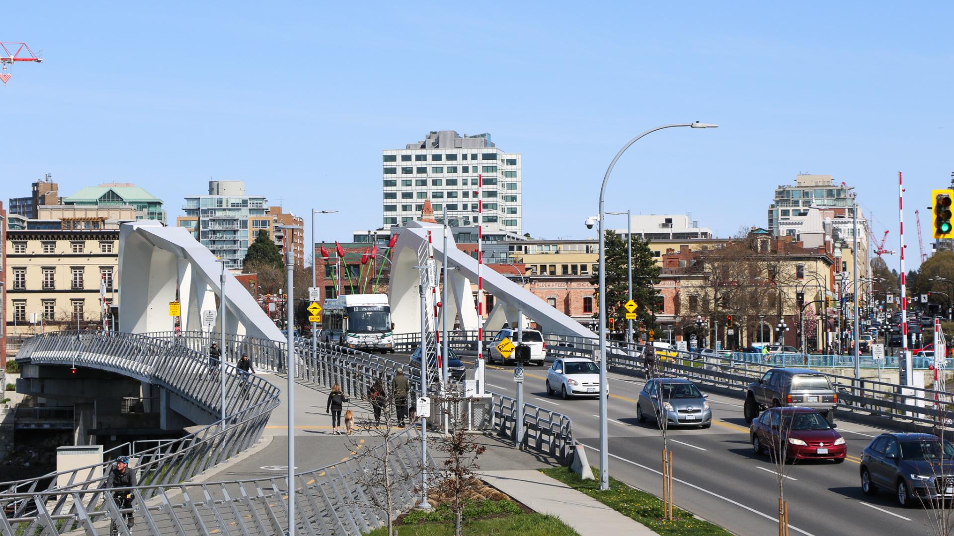 An image of cars, cyclists and pedestrians crossing the Johnson Street Bridge