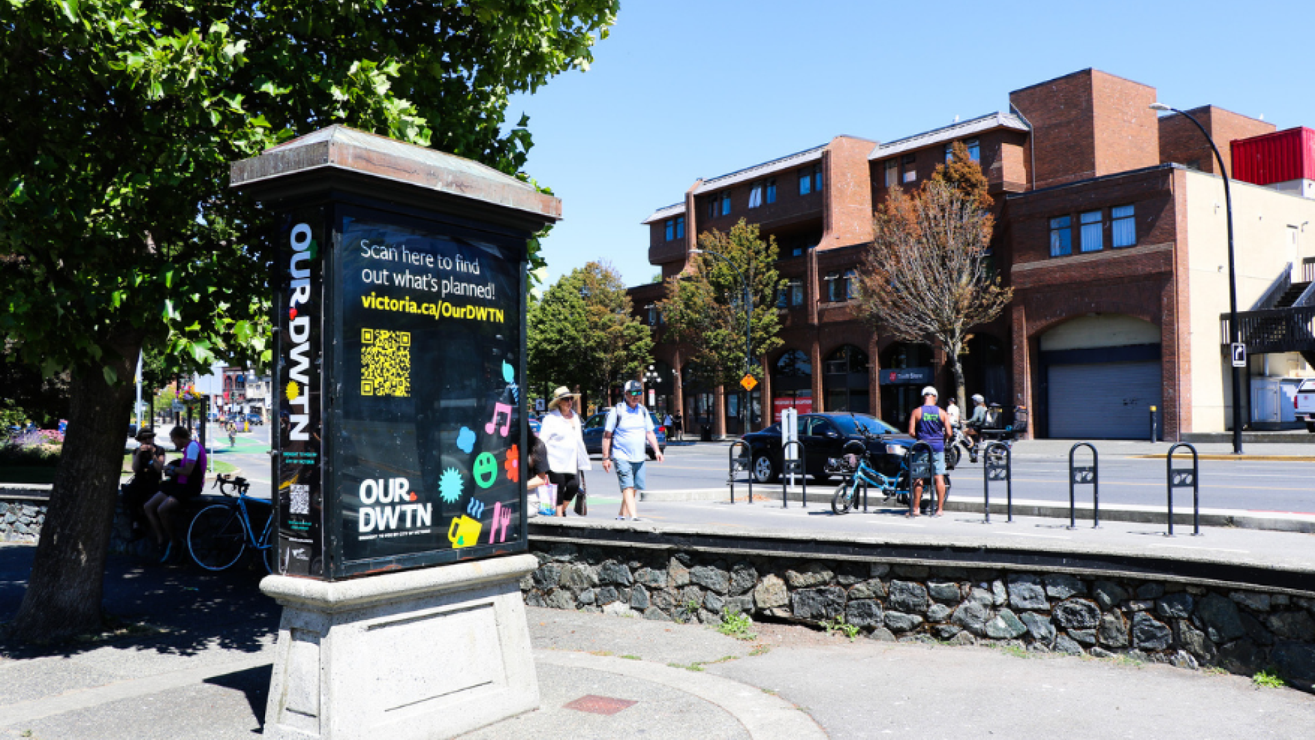 Photo of a downtown kiosk feature OUR DWTN branding