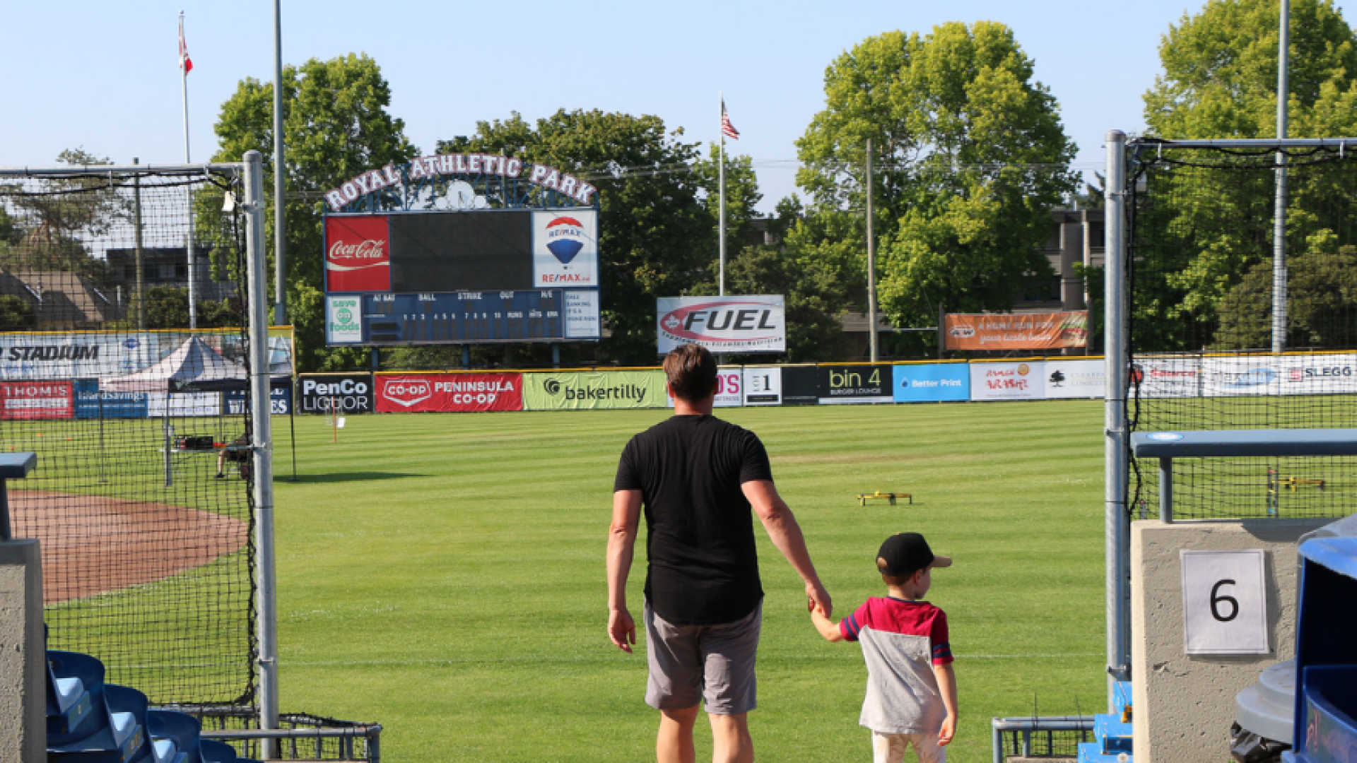 Parent and child walk down to the field at Royal Athletic Park 