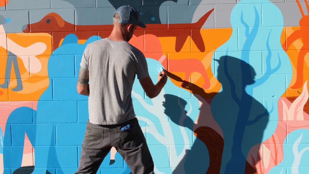 Artist painting a mural