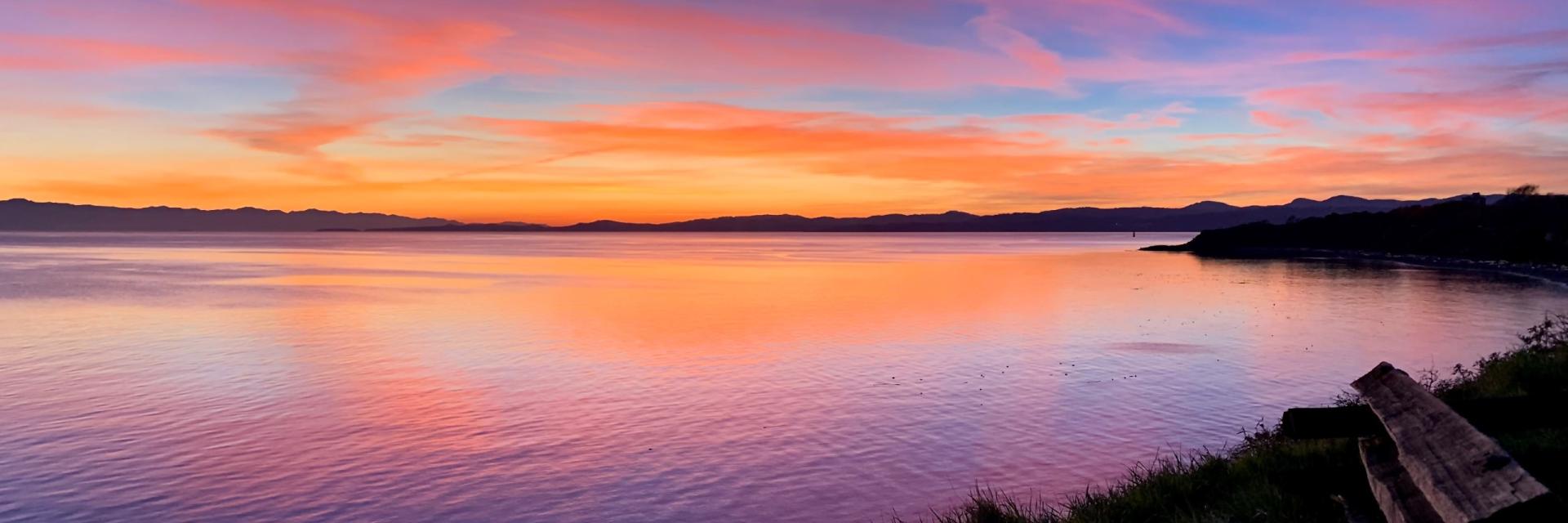 An image of a sunset over the water along Dallas Road