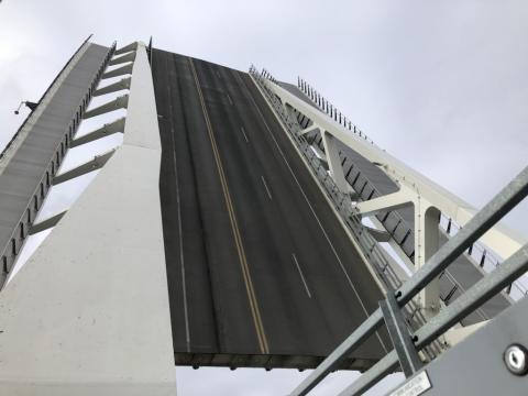Image of the Johnson St Bridge lifted for marine traffic to pass
